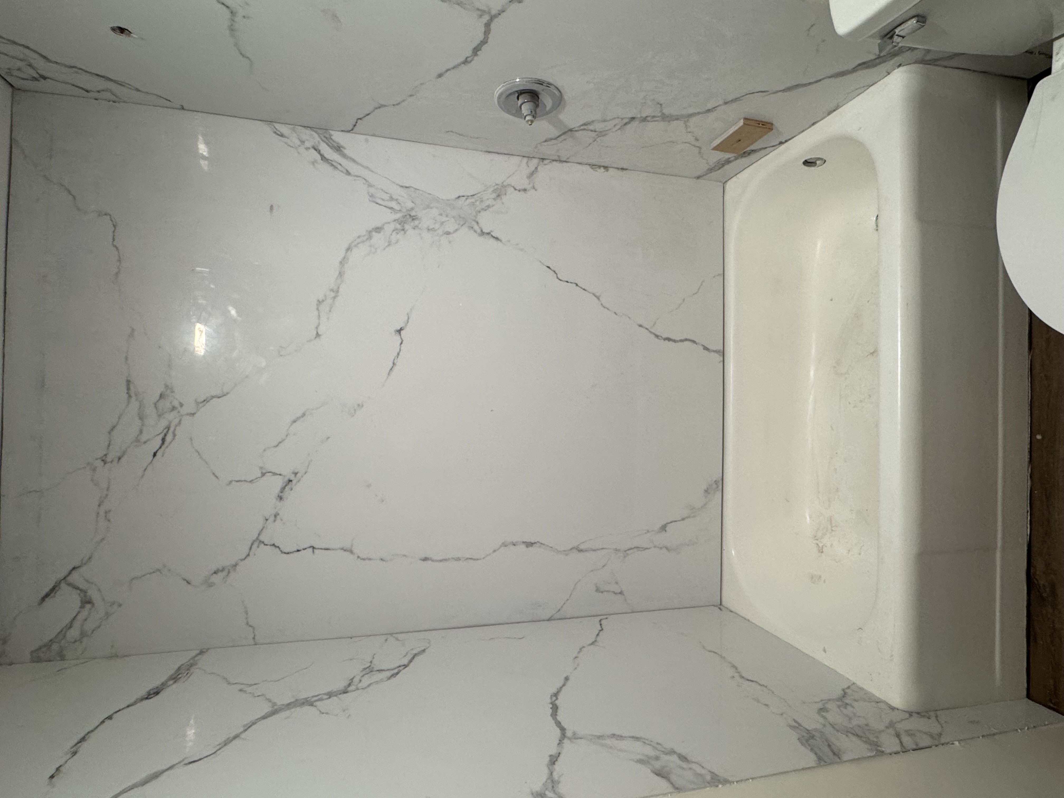 Engineered-marble tub surround installation in progress on an actual project