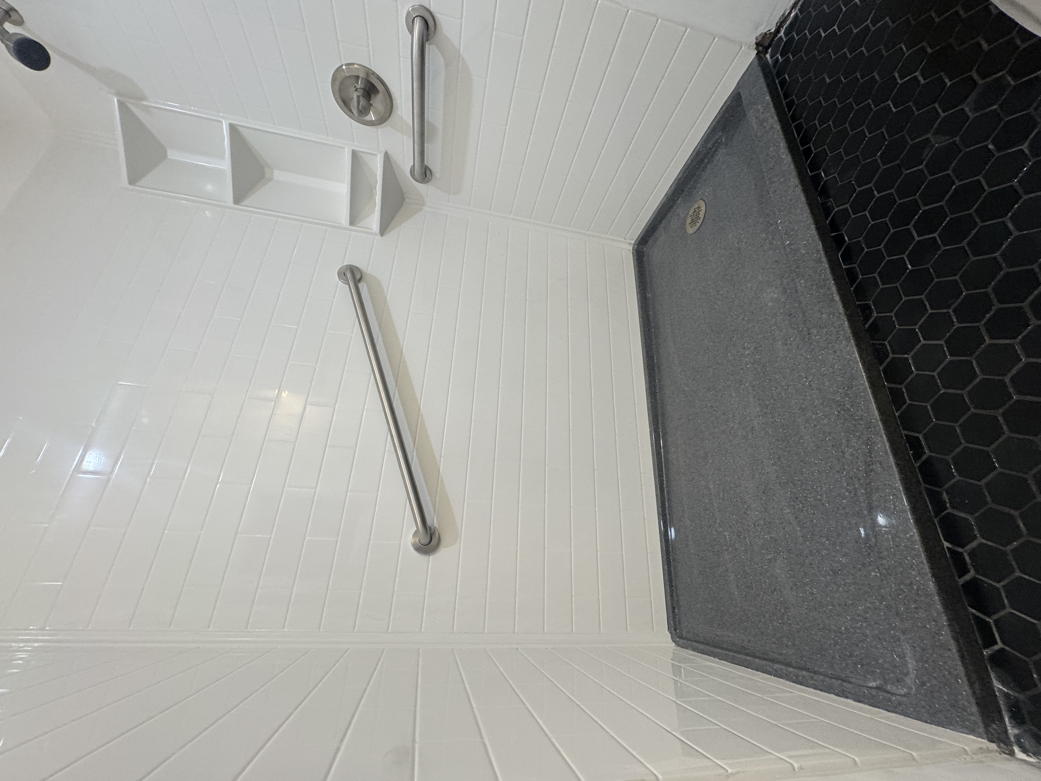 White subway-pattern Onyx shower with charcoal base